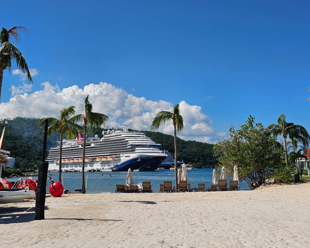 Luxury White sand beach front view with palm tress and docked cruise ship at moon palace Jamaica resort by DWEPP Jamaica.