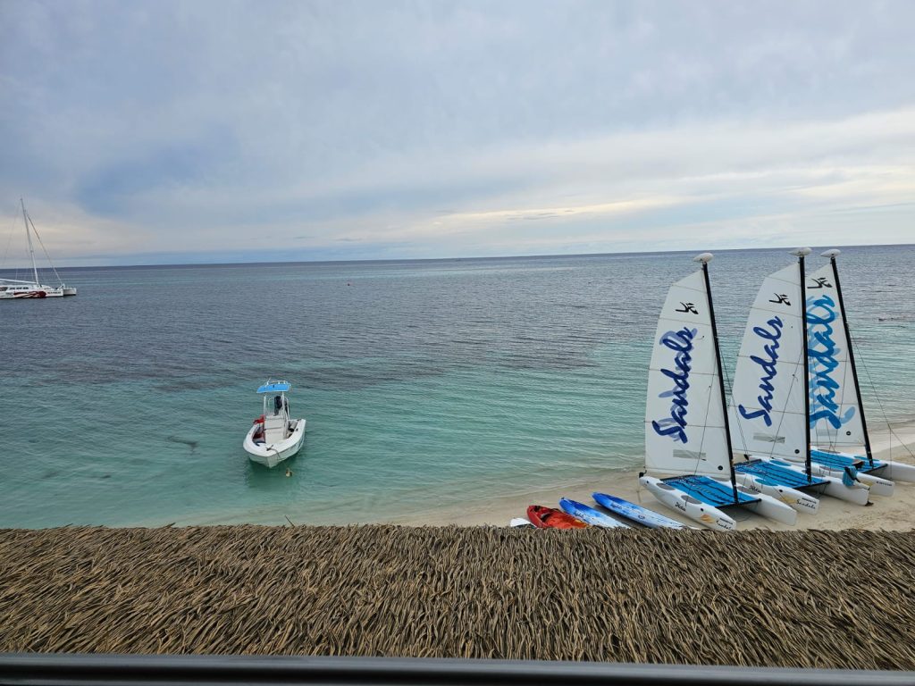 Luxy ocean front balcony View of turquoise water and sandals sail boats on the beach at sandals Montego bay Jamaica by DWEPP Jamaica 
